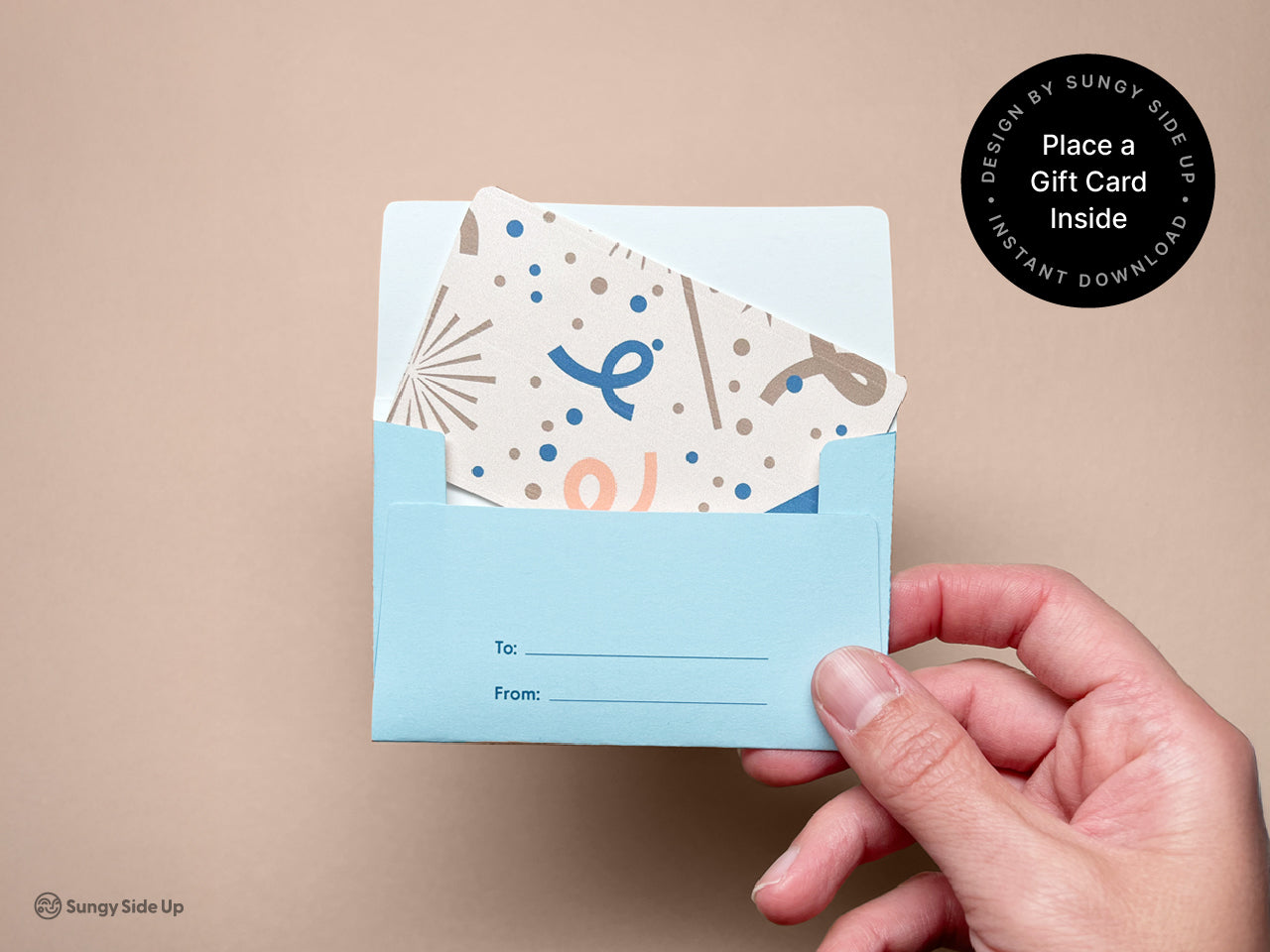 A hand inserting a gift card into the finished bear gift card holder envelope. The inside includes a labeled To and From area for personalizing. The soft blue design adds a playful and thoughtful touch to your gift. Great for birthdays, holidays, or thank-you gifts, this printable makes it easy to elevate a standard gift card into something memorable. A fun DIY project that adds heart and creativity to your gift-giving moments.