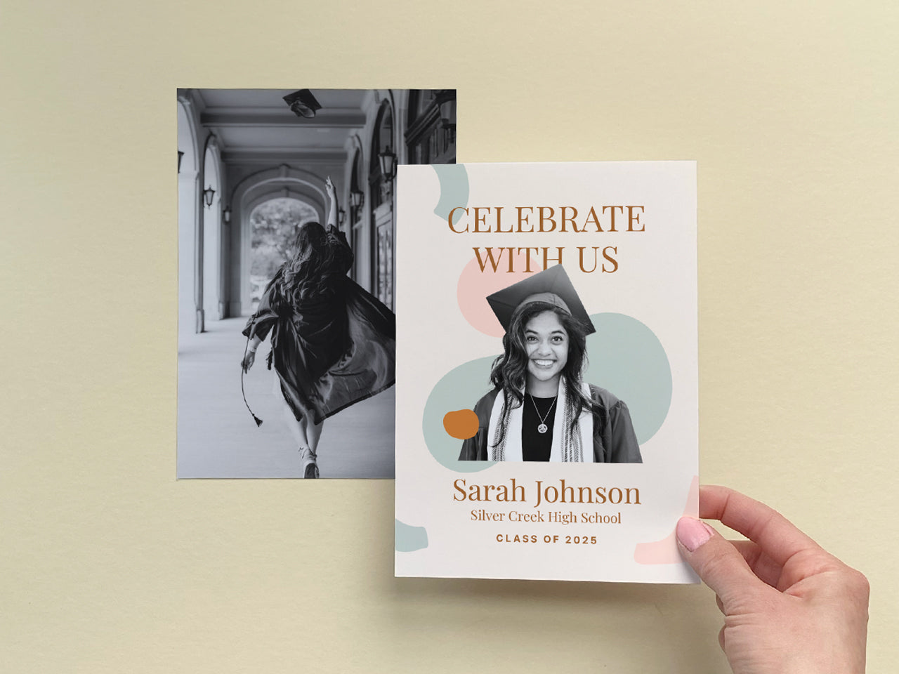 A personalized boho graduation announcement card, held in hand, showcasing a custom photo of the graduate with abstract modern design elements in soft earthy tones. The 5x7 printed graduation announcement card pairs beautifully with a black-and-white senior portrait, making it a unique and stylish way to celebrate a high school or college graduate. This customizable printed grad announcement is perfect for modern and minimalist graduation parties.
