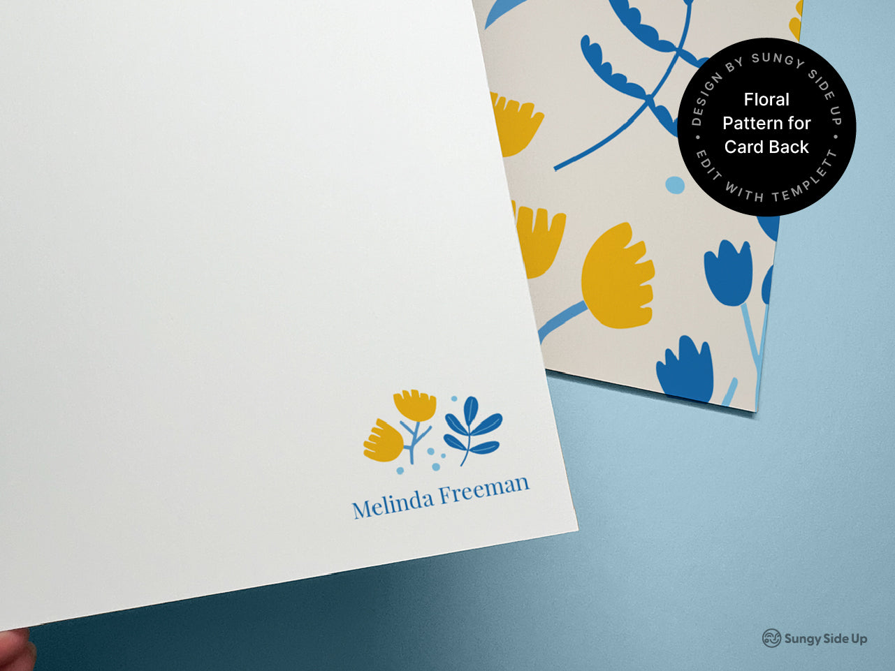 Close-up of personalized floral note card featuring editable name and matching back design with yellow and blue flowers. Part of a digital printable stationery set available for instant download. Customize using Templett to add your name or message. Includes coordinating floral pattern card back and A2 envelope template. Perfect for gifting, snail mail lovers, or custom thank you notes. Designed by Sungy Side Up for easy DIY printing at home.