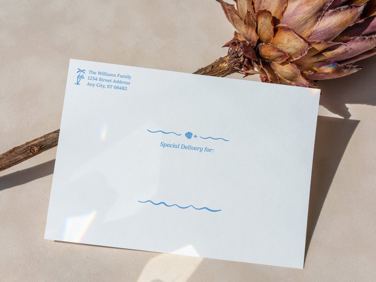 A close-up of a printed envelope included with the retro beach graduation invitation set. The envelope features a tropical palm tree return address and playful wavy elements, giving it a vintage coastal vibe. Special Delivery for is printed in a whimsical, beach-inspired font, making it perfect for a stylish, mailed graduation announcement. The perfect touch for a high-end, printed invitation set for a senior class celebration. Retro modern chic.