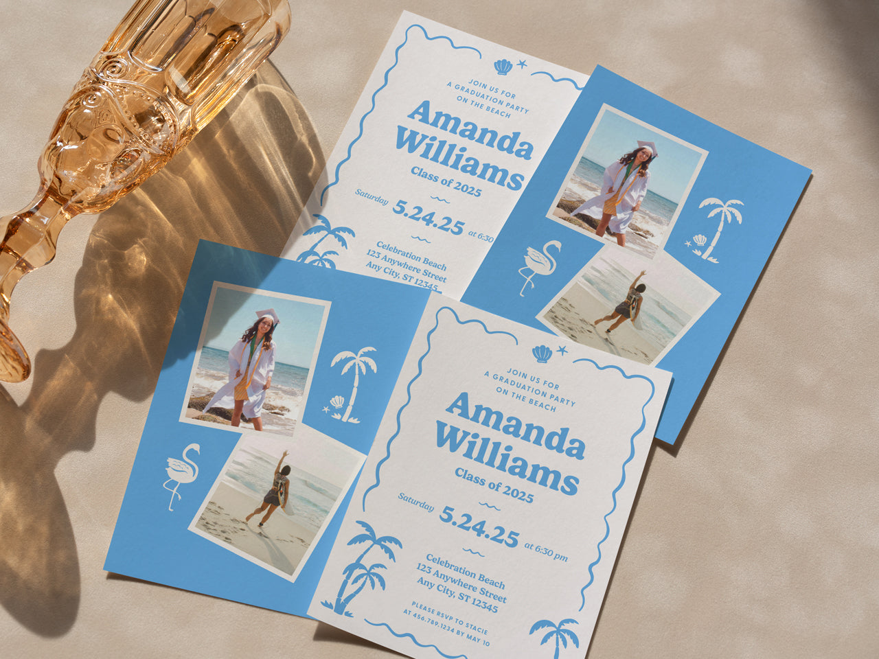 A close-up of retro beach graduation invitations and matching blue photo backer cards placed on a neutral surface with a vintage-style glass nearby. The elegant, tropical design is modern in style but with a vintage throwback. They feature soft blue hues, playful palm trees, and seashell accents, making these printed invitations ideal for a coastal, boho, or retro-inspired graduation celebration. Printed on white cotton stock, they are for grads who want to celebrate their milestone with style.