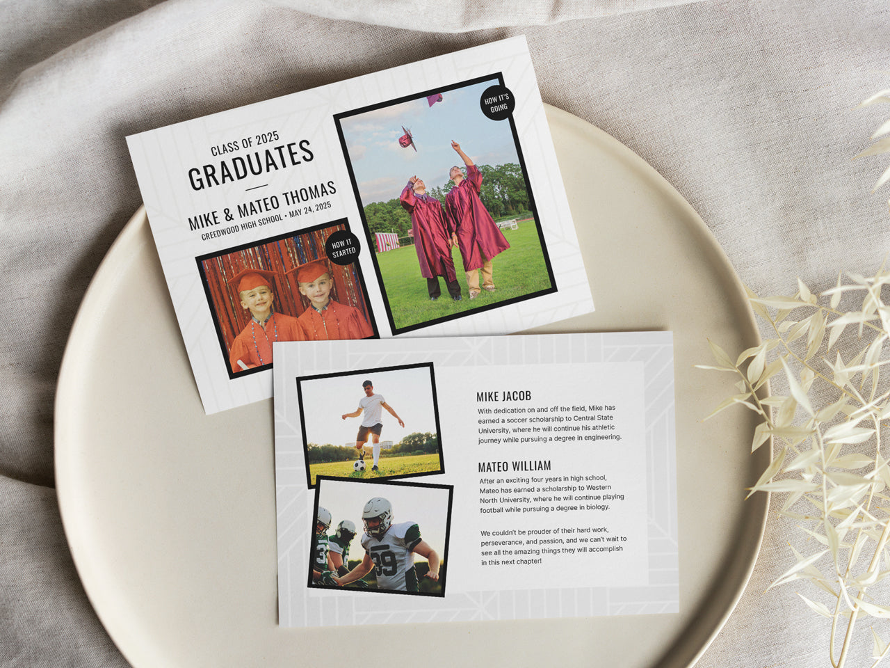 A set of printed twin graduation announcement cards displayed on a neutral ceramic plate with soft fabric underneath. The front card features a side-by-side childhood and senior photo of the twins in graduation attire. The back includes their names, achievements, and individual sports photos. A delicate dried floral arrangement adds a natural touch. The high-quality print and modern black and white design give it a polished, elegant look.