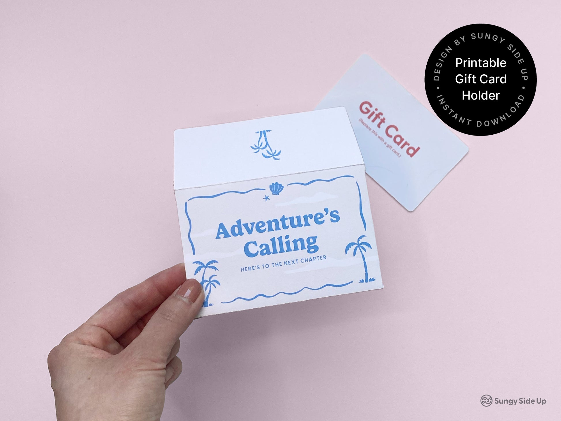 Hand holding a partially open retro beach-themed printable gift card holder with “Adventure’s Calling” design in blue. A sample gift card is placed nearby on a soft pink background, highlighting the envelope's use and scale. The gift card sleeve features palm tree and ocean wave graphics, perfect for travel, graduation, or celebration-themed gifts. Ideal for DIY gifting, this instant download offers a fun, creative way to present gift cards with a vintage beach style.
