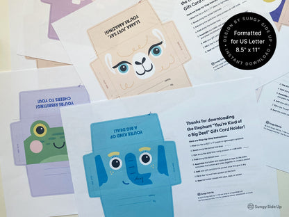 A variety of printable animal-themed gift card holders are displayed on a table, each designed for easy cutting and assembly. The printables include animals like a smiling llama, frog, and elephant, each with bright, cheerful colors. Instruction sheets detail step-by-step assembly guidance for creating fun, kid-friendly gift card holders. These digital files are formatted for US Letter size (8.5" x 11") paper, making it easy for home printing and crafting.