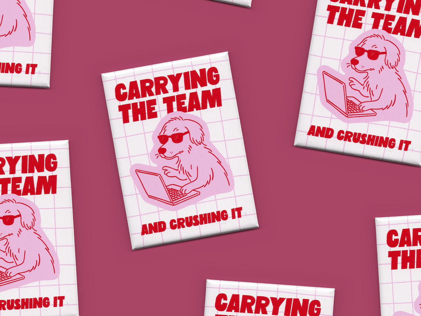 Multiple rectangular magnets scattered across a dark pink background featuring bold red text that says “Carrying the Team and Crushing It” with a pink illustration of a dog wearing sunglasses while working on a laptop over a light pink grid design.