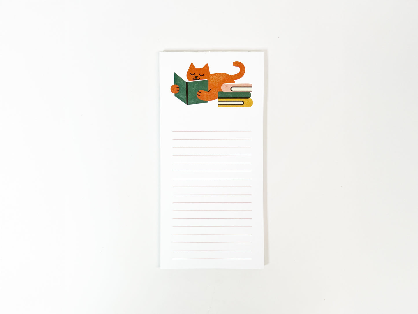 Tall, slim lined notepad featuring a cozy illustration of an orange cat lying down and reading a green book beside a small stack of books, with blank lined space below for notes on a white background.