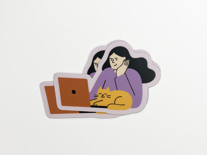 Three matte vinyl die-cut stickers stacked on a white background. Each sticker shows an illustration of a person with long dark hair wearing a lavender top, resting their head on one hand while looking at an orange laptop. A relaxed yellow cat with closed eyes is lying in front of the laptop. The stickers have a soft lavender border around the illustration