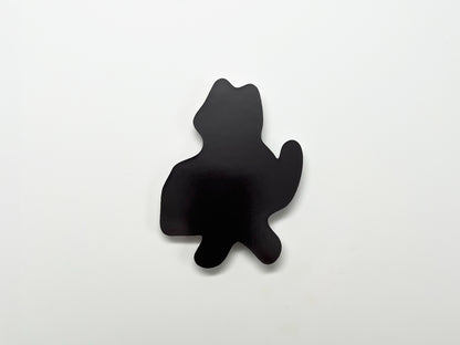 ChatGPT said:

Back view of a handmade die-cut magnet shaped like a standing cat with a raised tail. The solid black magnetic surface is shown against a plain white background.