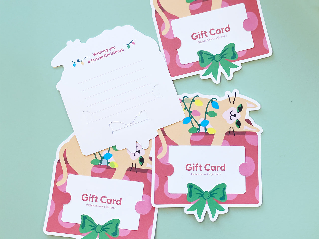 Multiple Christmas cat gift card holders arranged on a pastel green background, emphasizing the playful design, bright colors, and usability. These are perfect for Christmas stocking stuffers or creative holiday gift-giving for pet lovers.