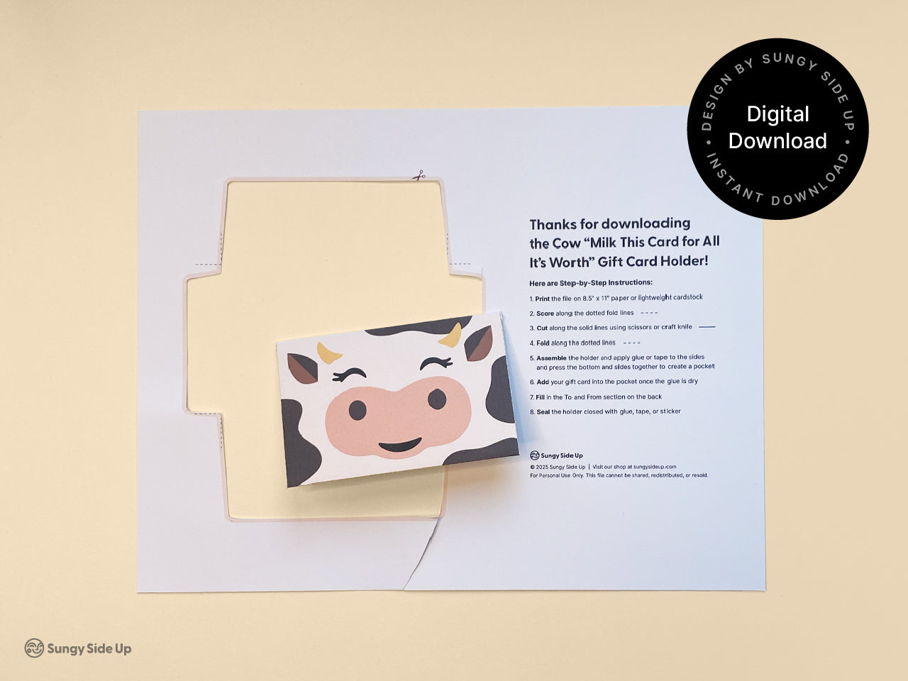 Flat lay of a printable cow gift card holder template with cutout edges, featuring a cute cow face and included instructions for assembling the envelope. This digital download is great for birthday gifts, baby showers, and teacher thank-you gifts. Designed for easy at-home printing and cutting, this farm animal gift card holder adds charm and humor to your DIY gifting. Perfect for classroom rewards or fun party favors.