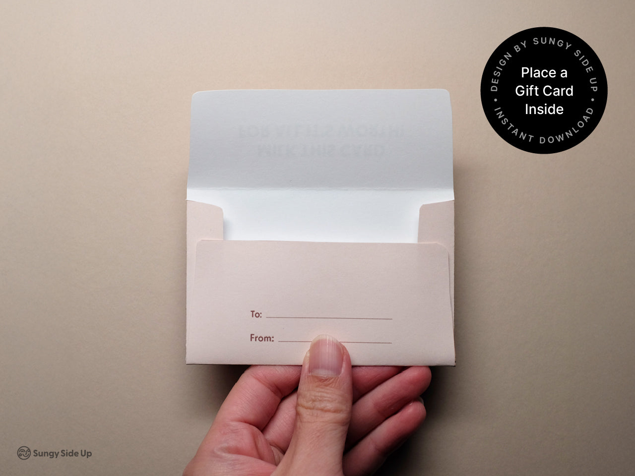 Hand holding an assembled printable cow gift card holder made from light pink cardstock, featuring a To and From section on the back. This DIY gift card envelope is perfect for teacher appreciation, kids’ birthdays, and farm-themed party favors. Ideal for instant download and home printing, this cute cow-themed template adds a fun touch to any celebration. Great for parents, teachers, or anyone gifting with personality.