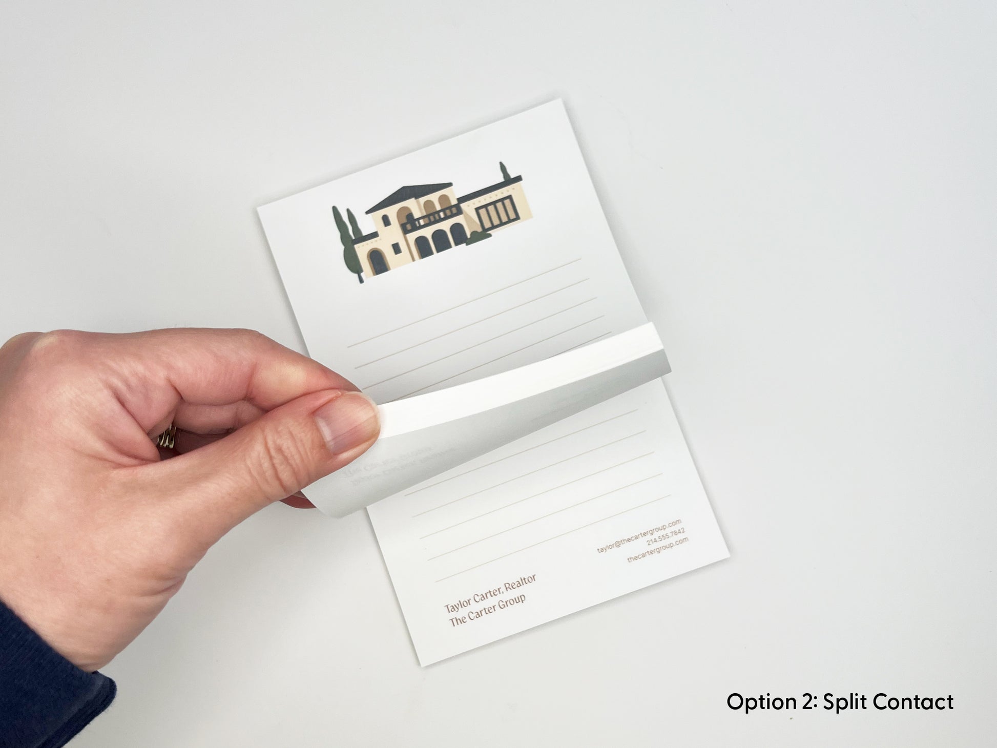 Hand peeling a page from personalized 4x6 real estate notepad, showing lined writing space, Mediterranean-style home illustration, and custom realtor branding for client gifts and marketing.