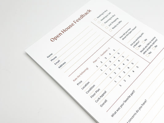 Angled close-up of a custom 5 × 8 Open House Feedback real estate notepad showing structured sections for buyer contact details, purchase readiness checkboxes, property rating scales for price, location, condition, floor plan and curb appeal, plus open-ended feedback fields designed for real estate open house follow-up.