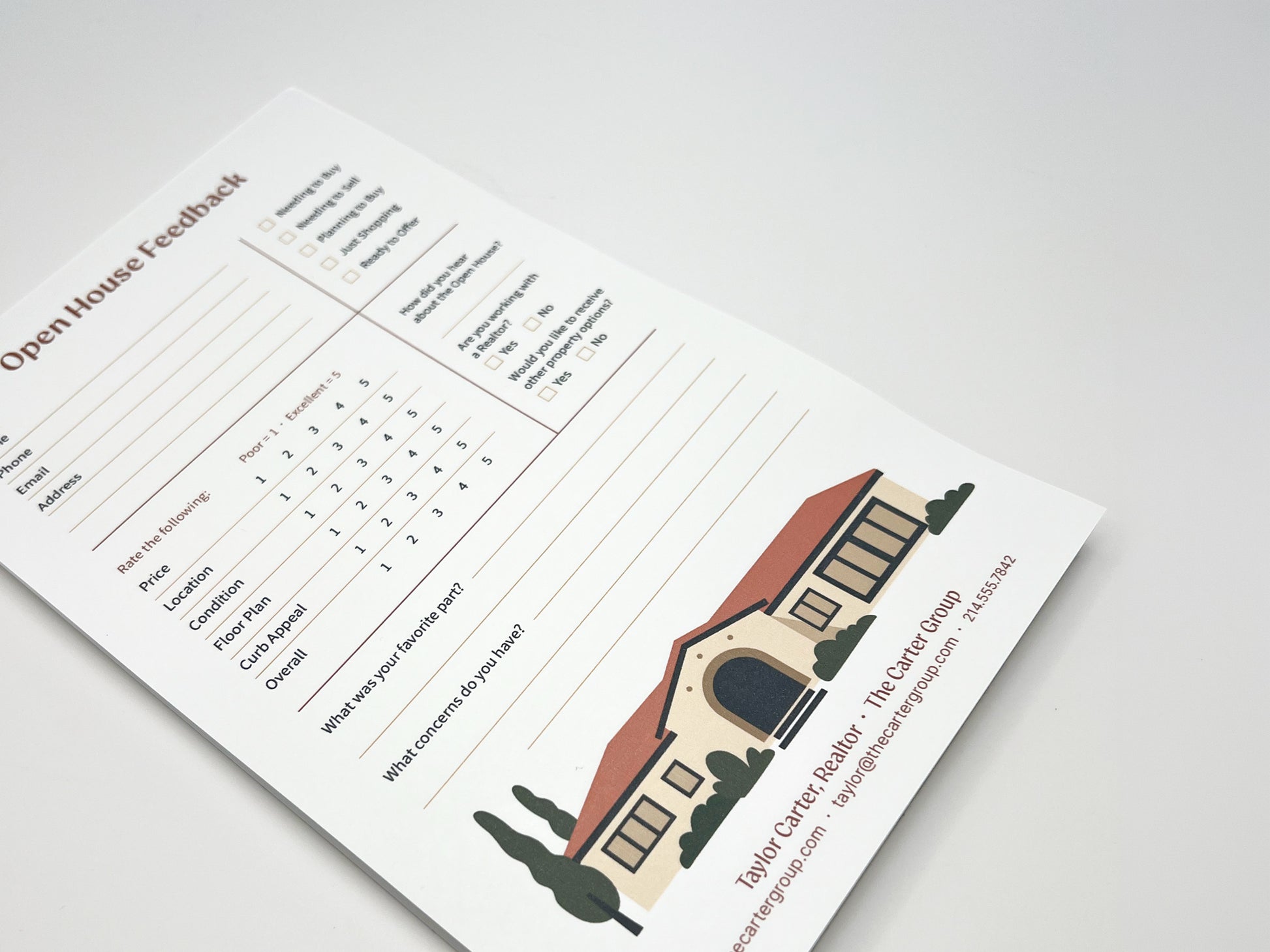 Angled view of a custom 5 × 8 Open House Feedback real estate notepad displaying structured buyer feedback fields, rating scales for property features, open comment sections, and a customizable branded footer with agent contact details and illustrated home graphic.