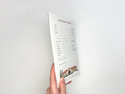 Side view of a hand holding a custom 5 × 8 Open House Feedback real estate notepad showing stacked tear-off sheets, structured buyer feedback layout, rating scales, and customizable branded footer designed for real estate open house follow-up.