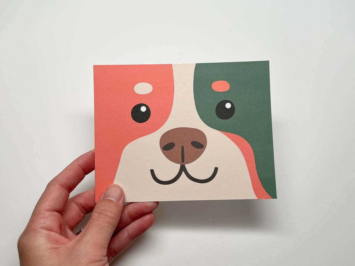 Dog bakery thank you card template featuring a playful coral, green, and cream illustrated dog face.