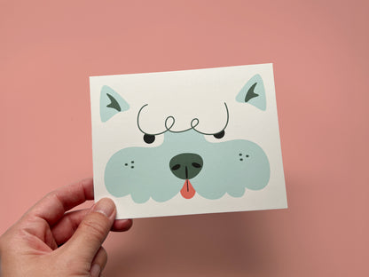 Dog bakery thank you card template with a playful blue and white illustrated dog face, held against a pink background.
