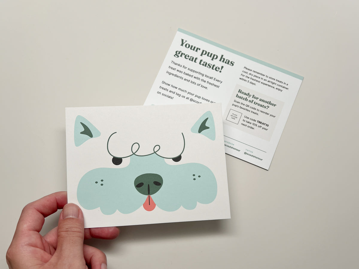 Dog bakery thank you card template showing a blue illustrated dog on the front with customizable thank you, treat care, reorder, and social media details on the back.