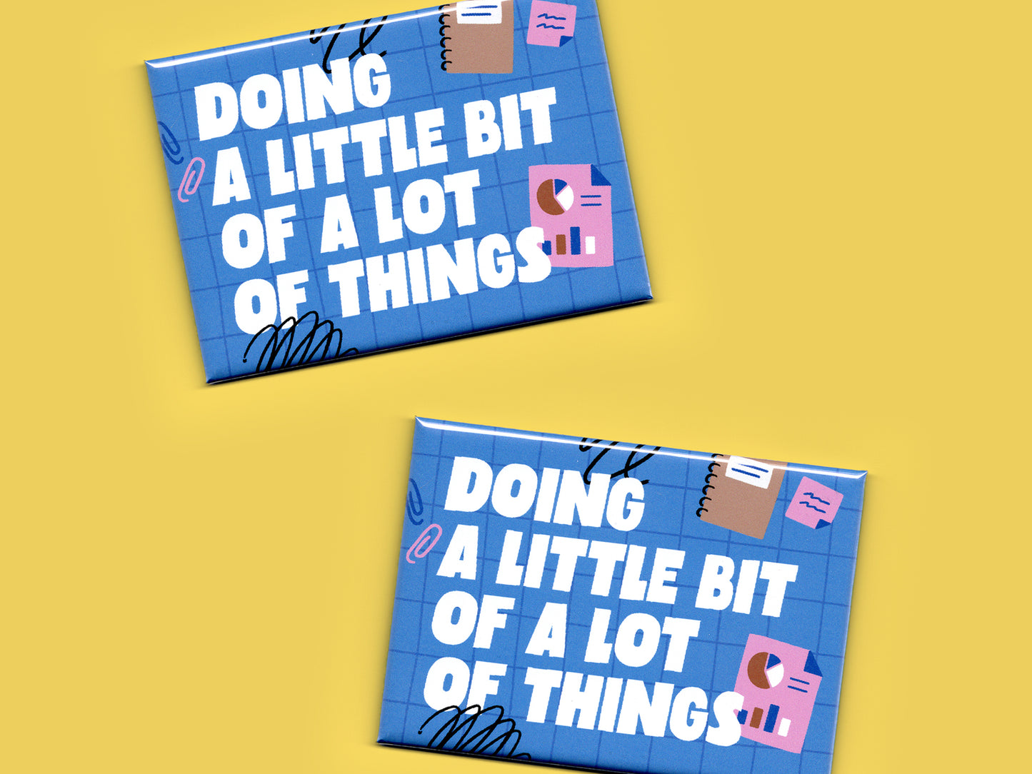 Two blue rectangular magnets displayed on a yellow background with bold white text reading “Doing a Little Bit of a Lot of Things.” Each magnet features a blue grid pattern with playful office-themed illustrations including charts, sticky notes, paper clips, and black scribble accents.