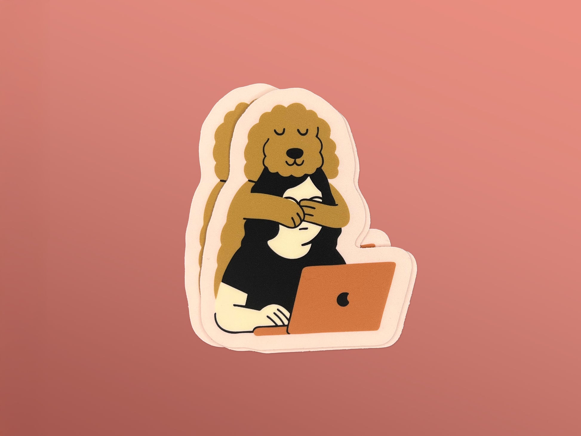Small stack of matte die cut stickers on a peach background, each showing an illustration of a golden doodle hugging its human from behind while the person works on a laptop. Stickers have a soft pink border and warm neutral colors.