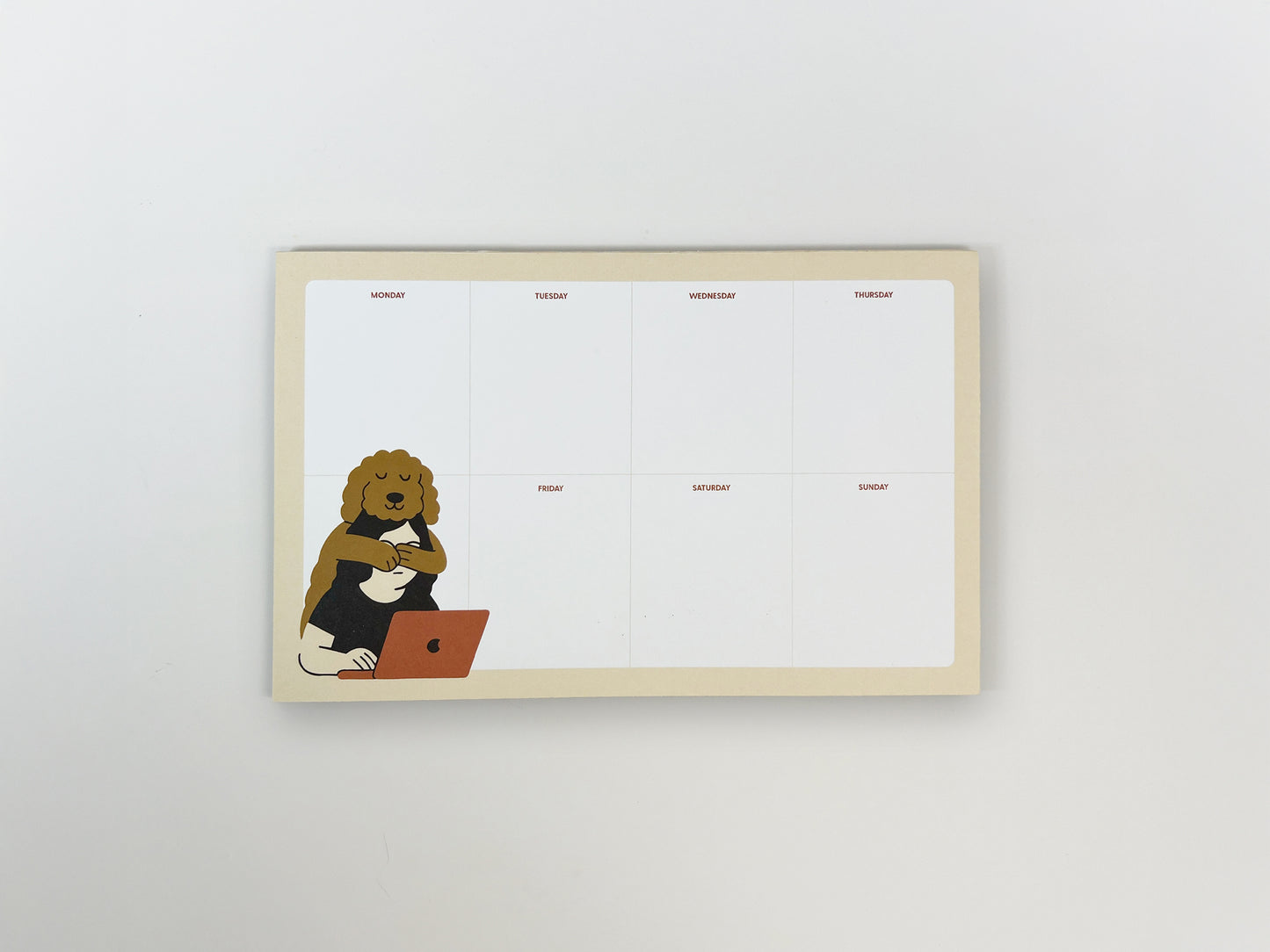 Top-down view of an 8.5 x 5.5 inch weekly planner notepad on a white background. The notepad features a clean Monday–Sunday layout with ample blank space and a playful illustration of a calm, curly-haired dog hugging a person working on a laptop in the lower left corner.