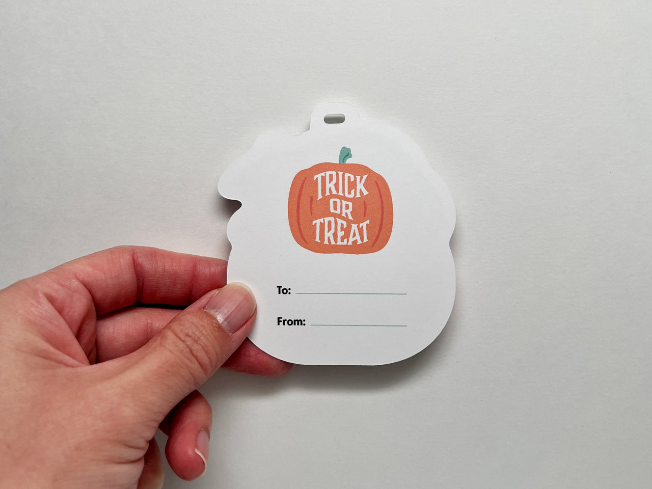 Illustration of an orange pumpkin with "trick or treat" and space to include the recipient's name.