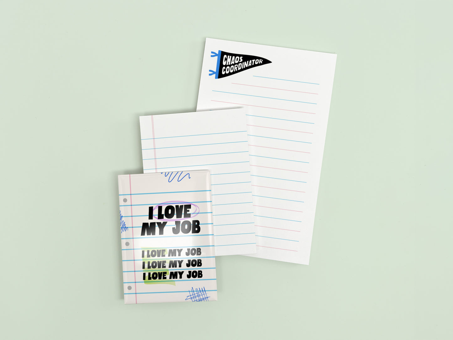 Funny coworker gift bundle featuring an I Love My Job magnet, mini lined notepad, and Chaos Coordinator notepad displayed on a light green background.