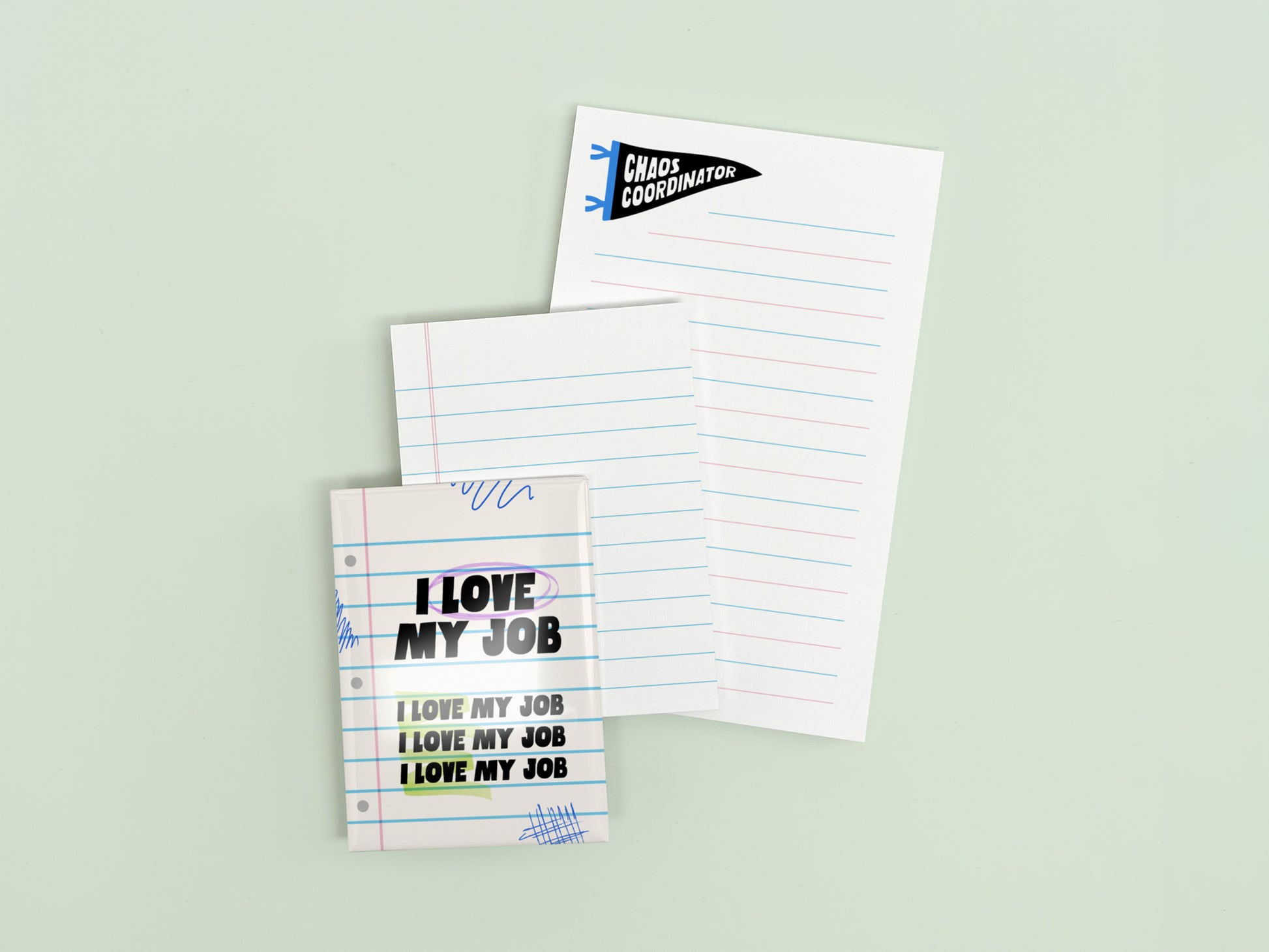 Funny coworker gift bundle featuring an I Love My Job magnet, mini lined notepad, and Chaos Coordinator notepad displayed on a light green background.