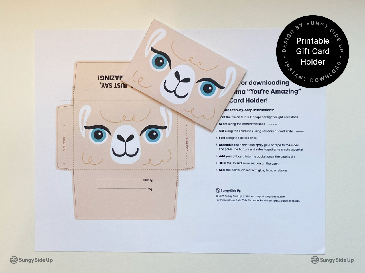 Flat lay image showing a llama gift card holder printable with a fully assembled version placed on top. The sheet includes a llama face design and step-by-step instructions. This visual highlights the before and after of the DIY project, ideal for shoppers searching for printable gift card envelopes, llama party supplies, birthday gift ideas, or teacher appreciation printables. A fun instant download perfect for quick and creative gifting.