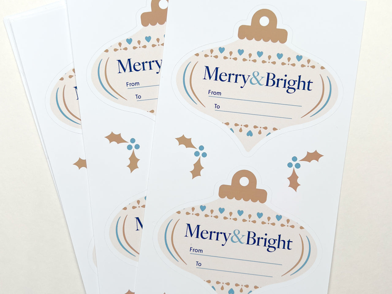 Close up of ivory gift labels with accents of blue and gold.