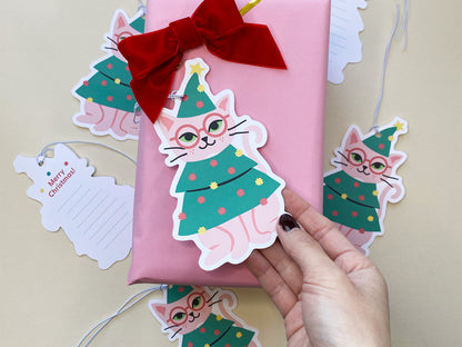 Christmas gift tags featuring a charming design of a pink cat in a decorated Christmas tree outfit and matching 'Merry Christmas!' message tags. A unique addition for holiday gift wrapping and seasonal decor
