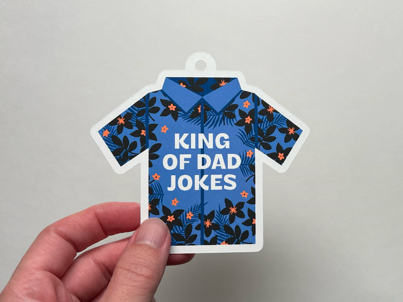 Hawaiian shirt illustration with text, "King of Dad Jokes" as a gift tag for Father's Day.