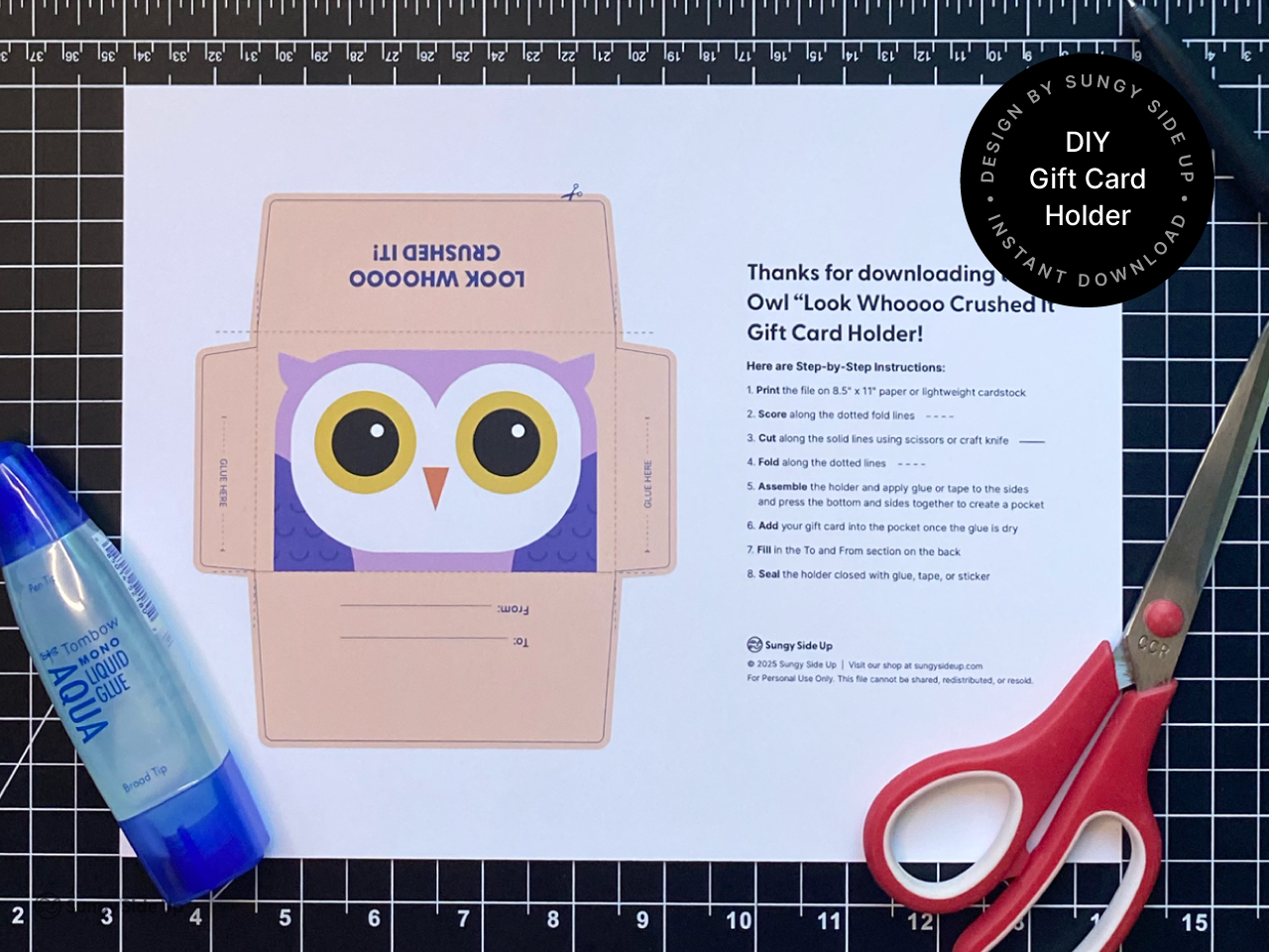 Printable owl-themed gift card holder template shown on a cutting mat with scissors and liquid glue beside it. Includes a step-by-step printed instruction sheet. This instant download PDF is designed for printing on 8.5 x 11 inch cardstock and makes a perfect DIY gift presentation for teachers, students, and kids. A great product image for Shopify listings focused on crafting, education, and holiday gifts.