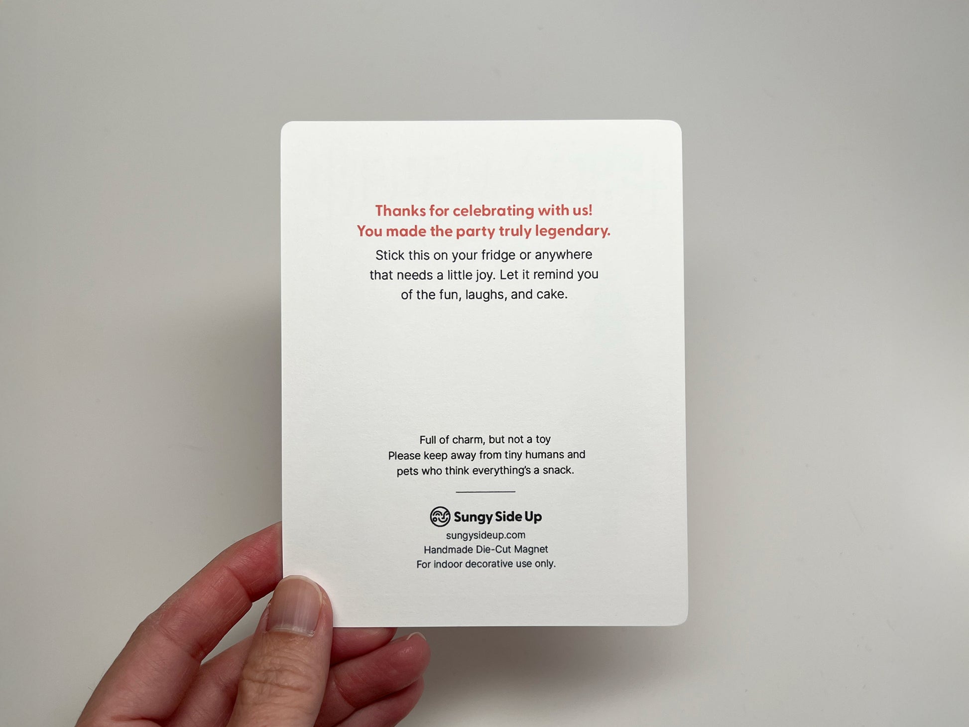 Back of the Party Legend Sasquatch magnet backing card featuring a thank you note in red and black text. It reads “Thanks for celebrating with us! You made the party truly legendary.” Includes a reminder to place the magnet on a fridge or surface for joy, along with a safety note to keep away from children and pets. Sungy Side Up branding and product details are printed at the bottom.