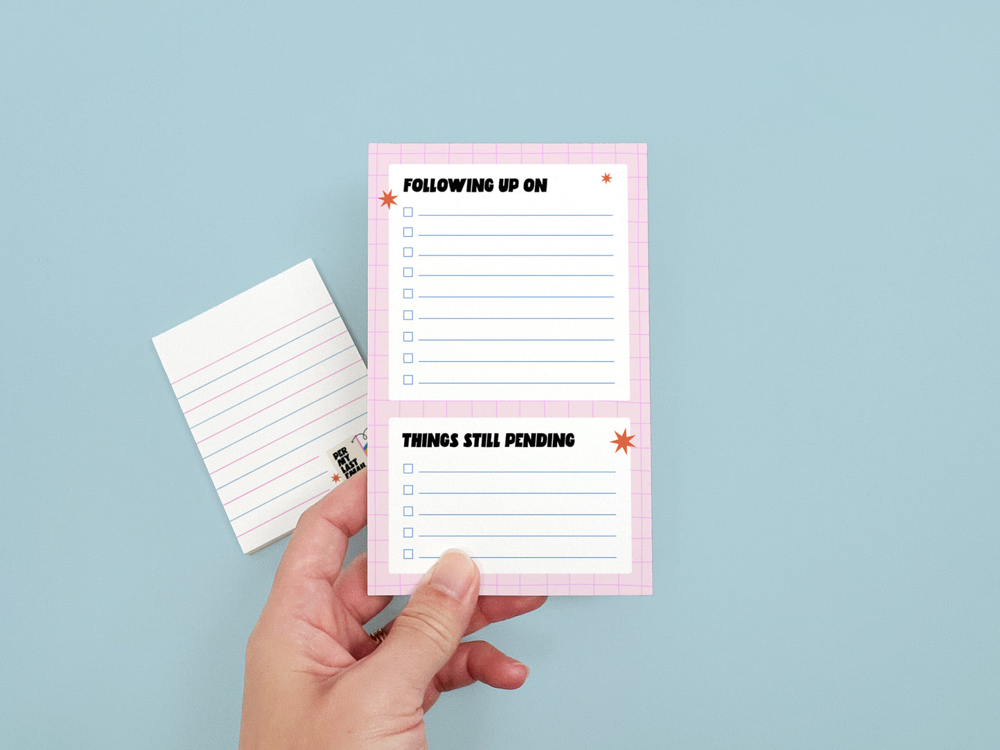 Hand holding a "Following Up On" and "Things Still Pending" office checklist notepad with a coordinating lined memo pad, perfect for work organization and coworker gifts.