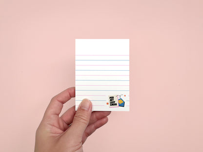 Hand holding a "Per My Last Email" 3x4 mini lined notepad with 50 tear-off sheets, funny office stationery for coworkers on a pink background.