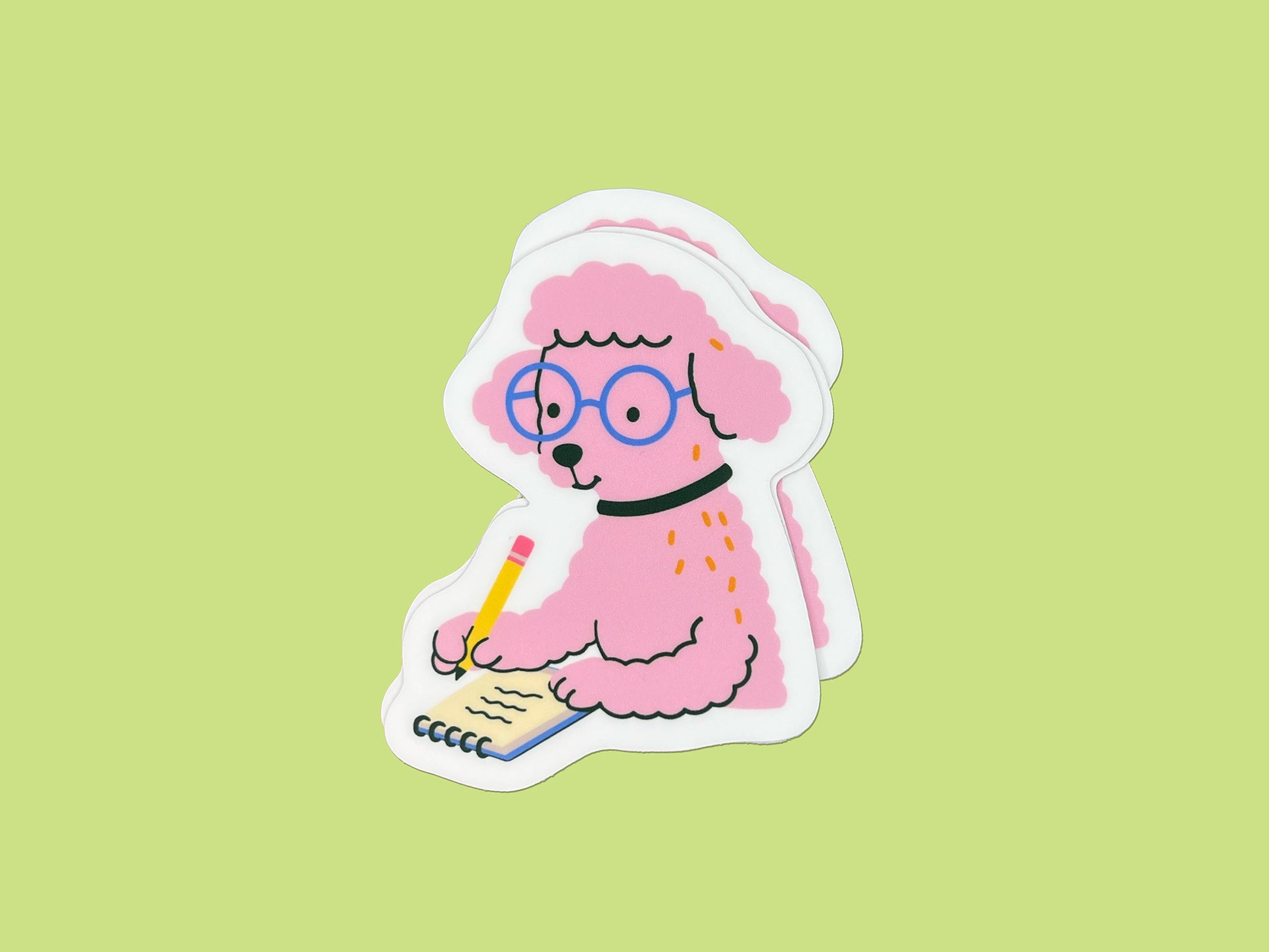 Three matte die-cut vinyl stickers stacked slightly offset, featuring a pink illustrated poodle wearing round blue glasses and a black collar while writing in a small spiral notebook with a yellow pencil. The poodle has fluffy textured fur and a calm, focused expression. Each sticker has a white border and is displayed against a light green background.