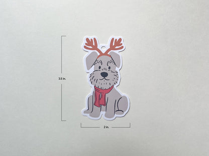 A reindeer Schnauzer holiday gift tag shown on a plain background with dimensions labeled: 3.5 inches tall and 2 inches wide. The tag features a cute Schnauzer dog with reindeer antlers and a red scarf, perfect for Christmas gift wrapping.