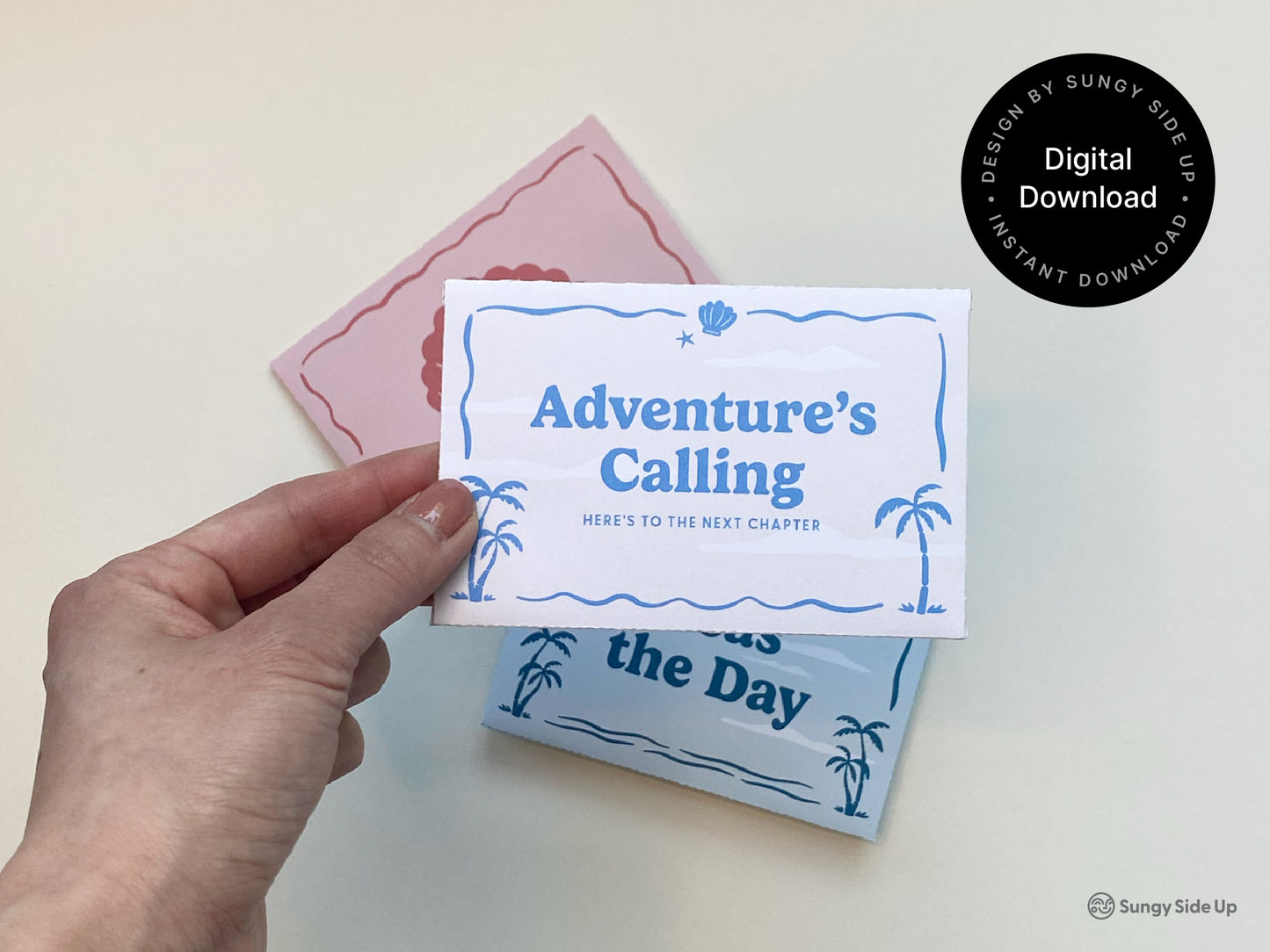 A hand holds a folded printable gift card holder with a blue retro beach theme and palm tree design, labeled "Adventure's Calling." In the background, two other printable gift card sleeves are visible—one in red with a shell illustration and one in light blue. These digital gift card envelopes are part of a downloadable bundle ideal for graduations, thank you gifts, coastal events, and summer celebrations. A black circle label reads “Digital Download” for instant access.