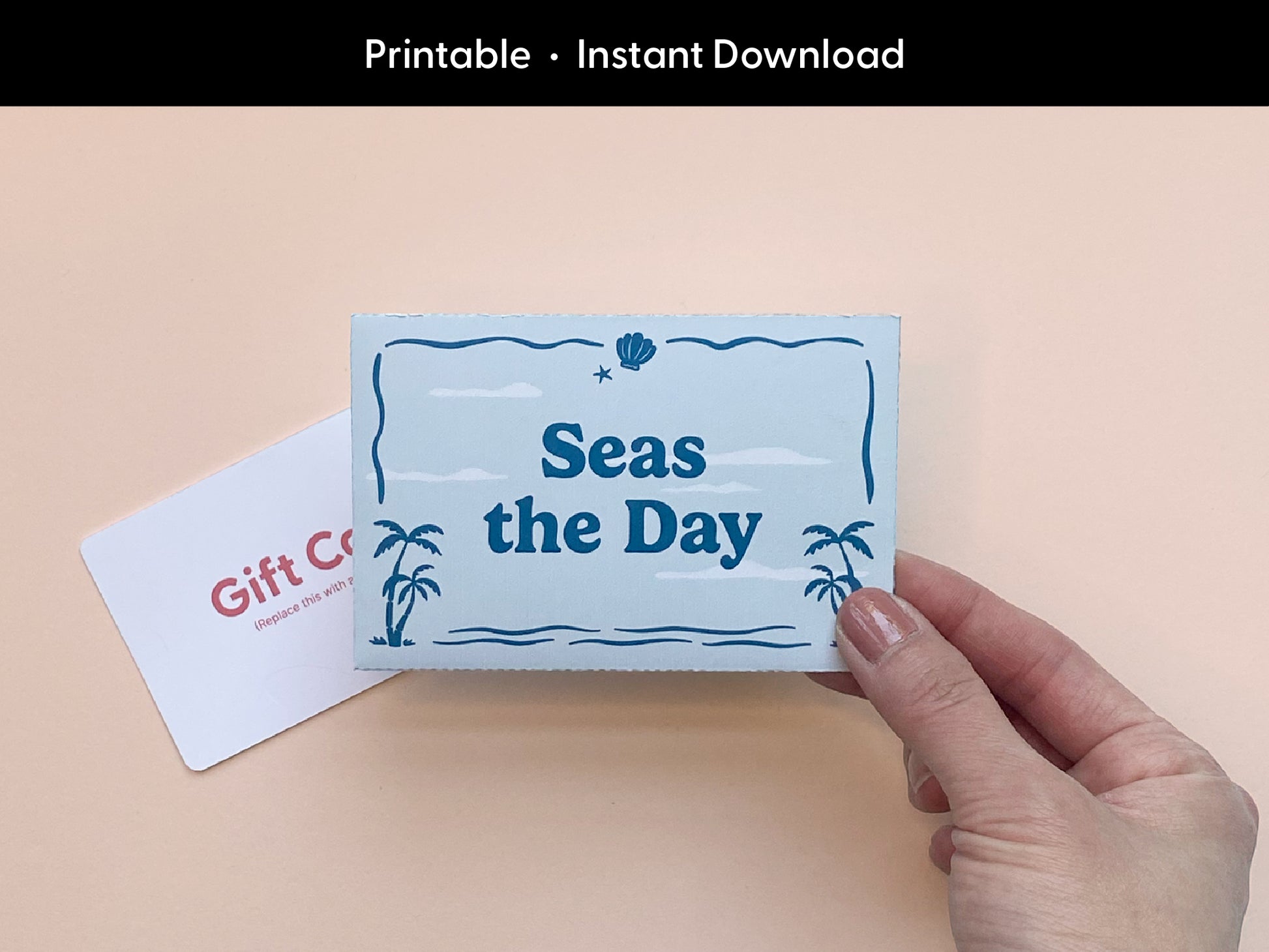 Hand holding a completed printable gift card holder with a beach inspired design that says Seas the Day in blue text. A blank gift card is placed beside it on a peach background. The holder features palm tree and ocean illustrations and is designed for easy at home assembly. This instant download is perfect for summer gifts birthdays or thank you occasions. A simple creative way to present a gift card with a fun tropical theme. Ideal for DIY gift giving from Sungy Side Up.
