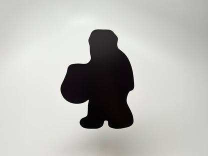 Back view of die-cut Halloween magnet shaped like a Sasquatch carrying a pumpkin bucket. Solid black magnetic surface designed to securely stick to fridges, lockers, and metal surfaces. Durable and lightweight Halloween décor, perfect for collectors of quirky cryptid and spooky magnets.
