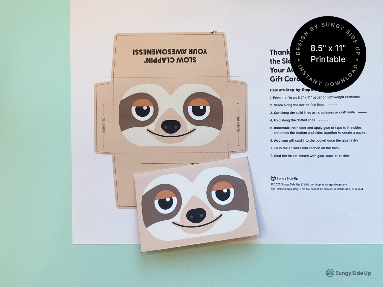 A digital sloth gift card holder printable shown on US letter sized sheet with folding instructions. A second copy of the holder is shown fully assembled on top, featuring a cheerful sloth face design. The background is mint green, adding a playful feel. This is an instant download product perfect for anyone looking to create a handmade envelope for gifting with a fun, animal-themed twist. Great for birthdays, classroom rewards, or special thank-yous.