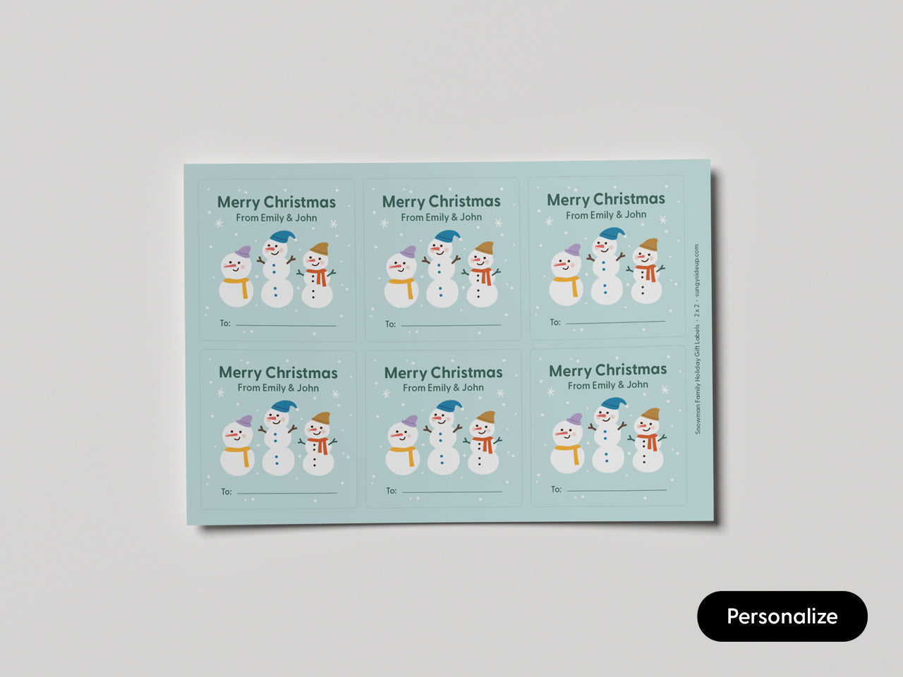 Single view of one sheet of holiday gift labels featuring an illustration of a snowman family.