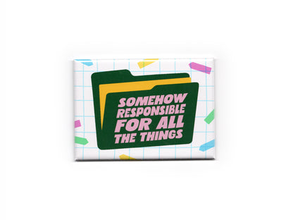 Rectangular magnet with a white grid background and colorful confetti accents. A dark green file folder graphic features pink text that reads “Somehow Responsible for All the Things.”