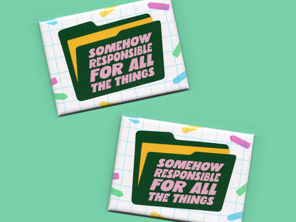 Two “Somehow Responsible for All the Things” magnets displayed on a mint green background. The magnets feature a white grid pattern, colorful confetti accents, and a dark green file folder graphic with pink text.