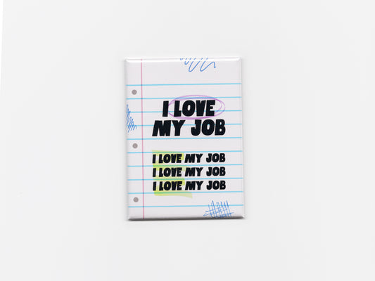 Square fridge magnet centered on a plain light background, designed like a sheet of lined notebook paper with blue horizontal lines and a pink margin. The magnet reads “I LOVE MY JOB” in bold black text at the top, with the phrase repeated three times below in smaller text. The word “LOVE” is circled in purple, and the repeated lines are highlighted in soft yellow and green. Blue pen-style doodles appear in the corners, and the magnet has a smooth, glossy finish with slightly rounded edges.