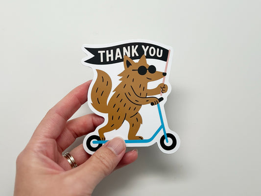 Handmade die-cut magnet featuring a quirky woodland creature on a blue scooter holding a “THANK YOU” flag. Fun, unique fridge magnet gift for animal lovers, friends, or coworkers. Cute thank you magnet perfect for quirky home décor.