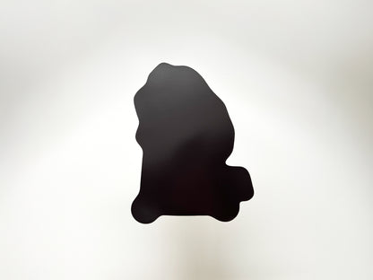 Back view of a die-cut fridge magnet shaped like a yeti riding a scooter. Solid black magnetic backing shown against a white background. Durable novelty magnet gift for music lovers, scooter fans, and quirky home or kitchen decor.