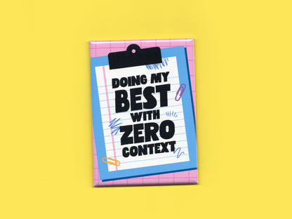 Rectangular magnet with a pink grid background and a blue clipboard illustration holding lined paper. Bold black text reads “Doing My Best With Zero Context.” The magnet is displayed against a bright yellow background.