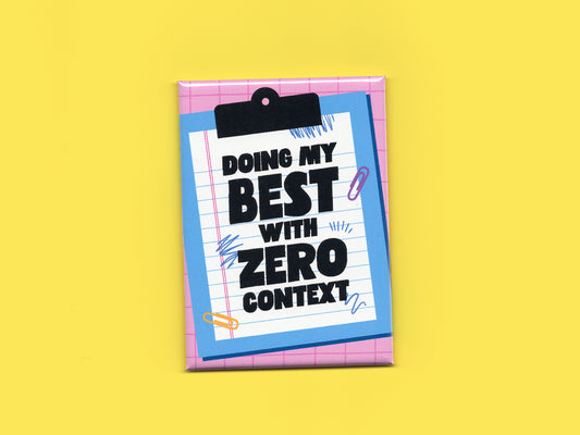 Rectangular magnet with a pink grid background and a blue clipboard illustration holding lined paper. Bold black text reads “Doing My Best With Zero Context.” The magnet is displayed against a bright yellow background.